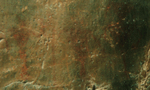 Closeup of petroglyphs of human figures.